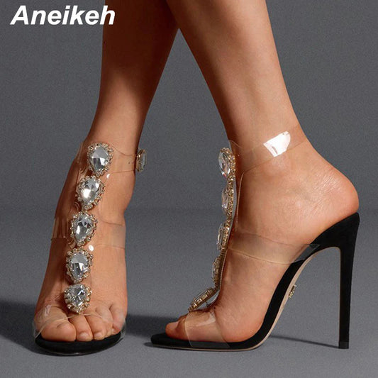 Step out in style with Aneikeh's party sandals, featuring PVC straps, a heart-shaped crystal buckle, and thin heels that are sharp enough to drill! Perfect for those who want to add a touch of sparkle and a dash of danger to