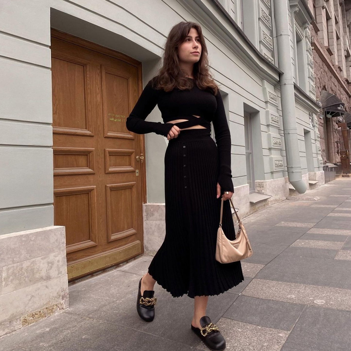 Get ready to fall in love with the 'Tossy'—a chic, white knit two-piece set for women. This ensemble features a ribbed crop top paired with a pleated midi skirt, perfect for those crisp autumn days. It's the ultimate blend