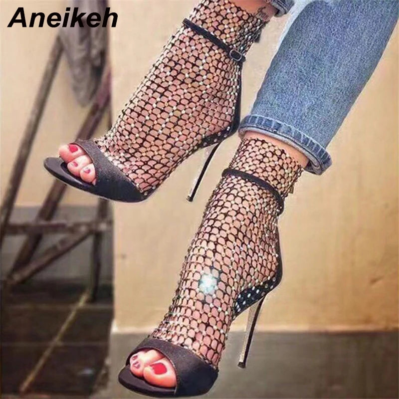 Discover the Aneikeh Glitter Gladiator Sandals: a stunning pair of high-heeled, peep-toe pumps that blend sexiness with comfort, thanks to their airy mesh design and sleek, thin heels.