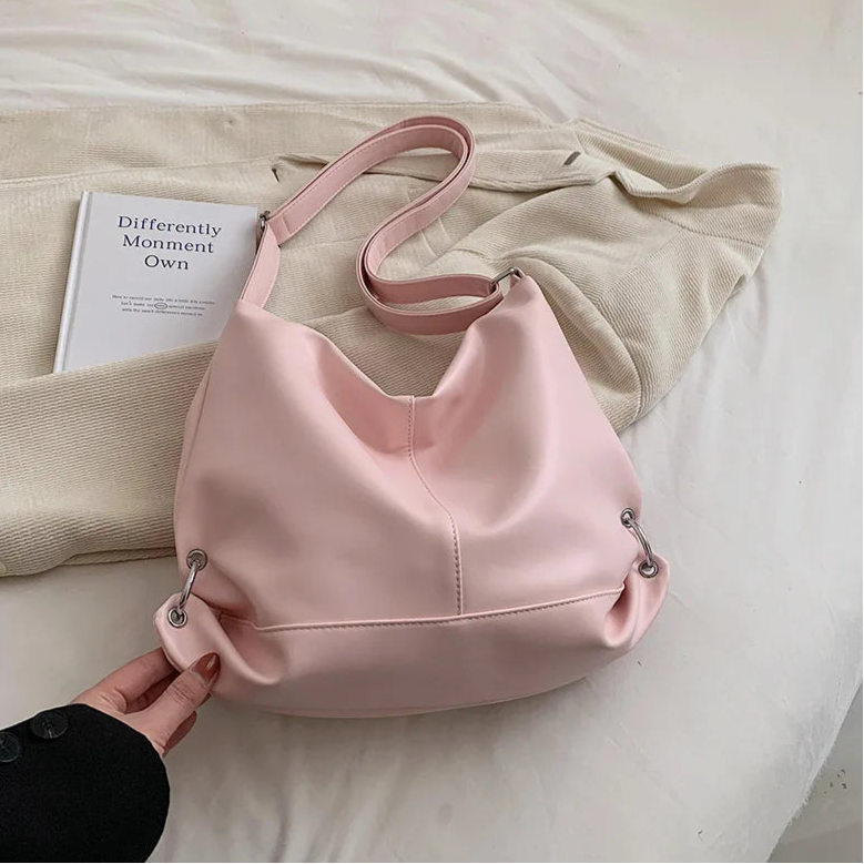 **"Textured Soft Leather Handbag – Pink Crossbody Tote"**  
Add a pop of personality with Tye Meshun's textured soft-leather handbag. Featuring a spacious interior and a versatile crossbody strap, this pink tote effortlessl