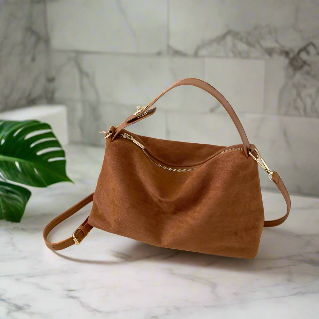 **"Suede Shoulder Bag"**  
Handpicked for Tye Meshun's Boutique, this versatile suede crossbody blends timeless simplicity with high-quality construction. With a secure zipper closure and chic solid design, it's perfect for e