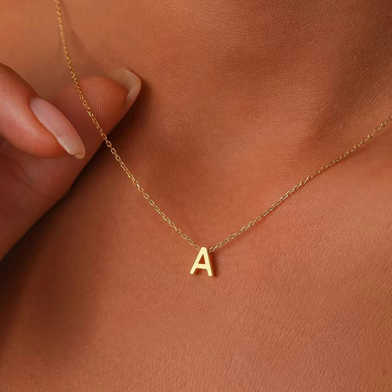 **"Stainless Steel Initial Necklace"**  
Hand-selected for Tye Meshun's Boutique, this gold-tone choker features cut letters for a personal touch. Perfect for layering or gifting, it’s a timeless statement piece.