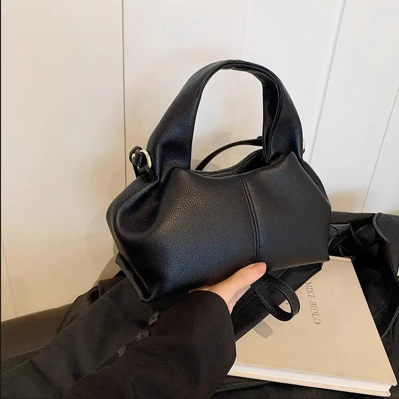 Here’s a season- and date-neutral version:

**"Women's Dumpling Shoulder Crossbody Bag"**  
Elevate your look with Tye Meshun's luxurious top-handle hobo bag. Featuring a chic "dumpling" silhouette, this versatile piece tra