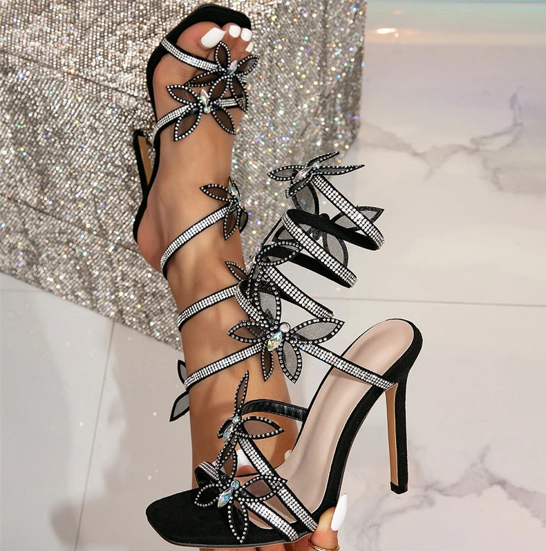 Eilyken Fashion offers sexy peep-toe sandals with crystal butterfly-knot, ankle straps, and stiletto high heels for women, perfect for making a statement with any outfit.