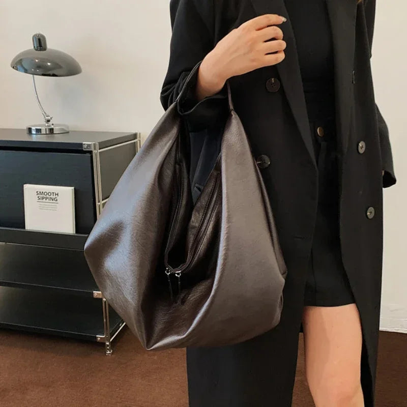 **"Bold Leather Shoulder Bag"**  
Add excitement to your everyday look with Tye Meshun's bold leather shoulder bag. Its roomy hobo design and luxurious craftsmanship make it as functional as it is stylish. Perfect for travel,