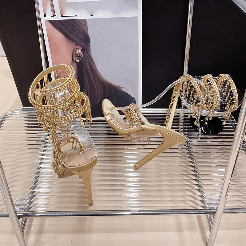 Discover the Aneikeh Fashion collection: dazzling rhinestone sandals with a string bead design, featuring a stiletto heel and wrap strap, complete with a peep toe for a touch of elegance.