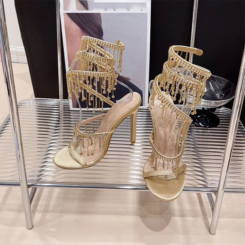 Discover the Aneikeh Fashion collection: dazzling rhinestone sandals with a string bead design, featuring a stiletto heel and wrap strap, complete with a peep toe for a touch of elegance.