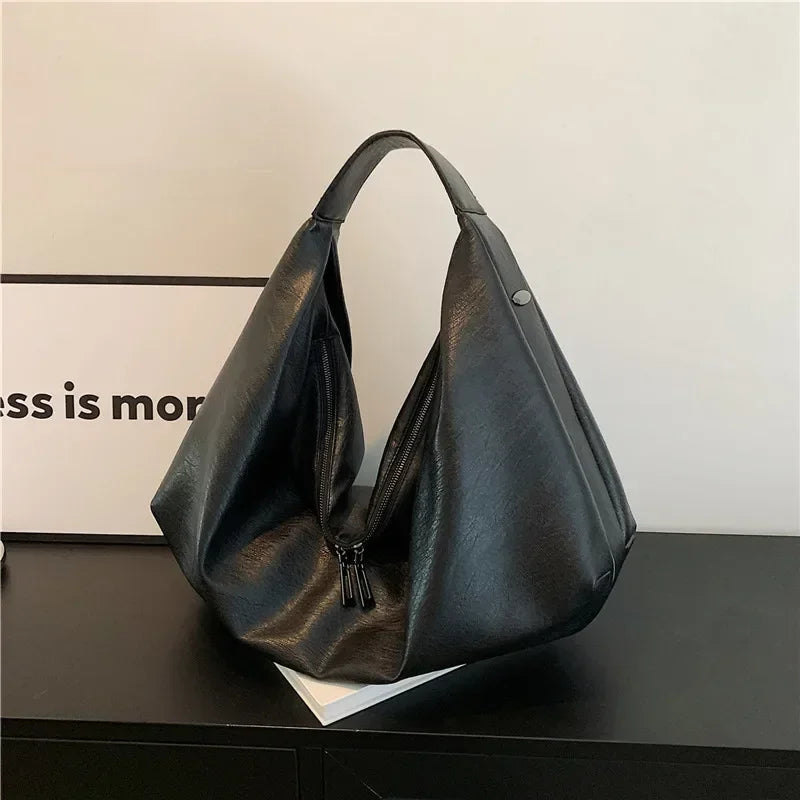 **"Bold Leather Shoulder Bag"**  
Add excitement to your everyday look with Tye Meshun's bold leather shoulder bag. Its roomy hobo design and luxurious craftsmanship make it as functional as it is stylish. Perfect for travel,