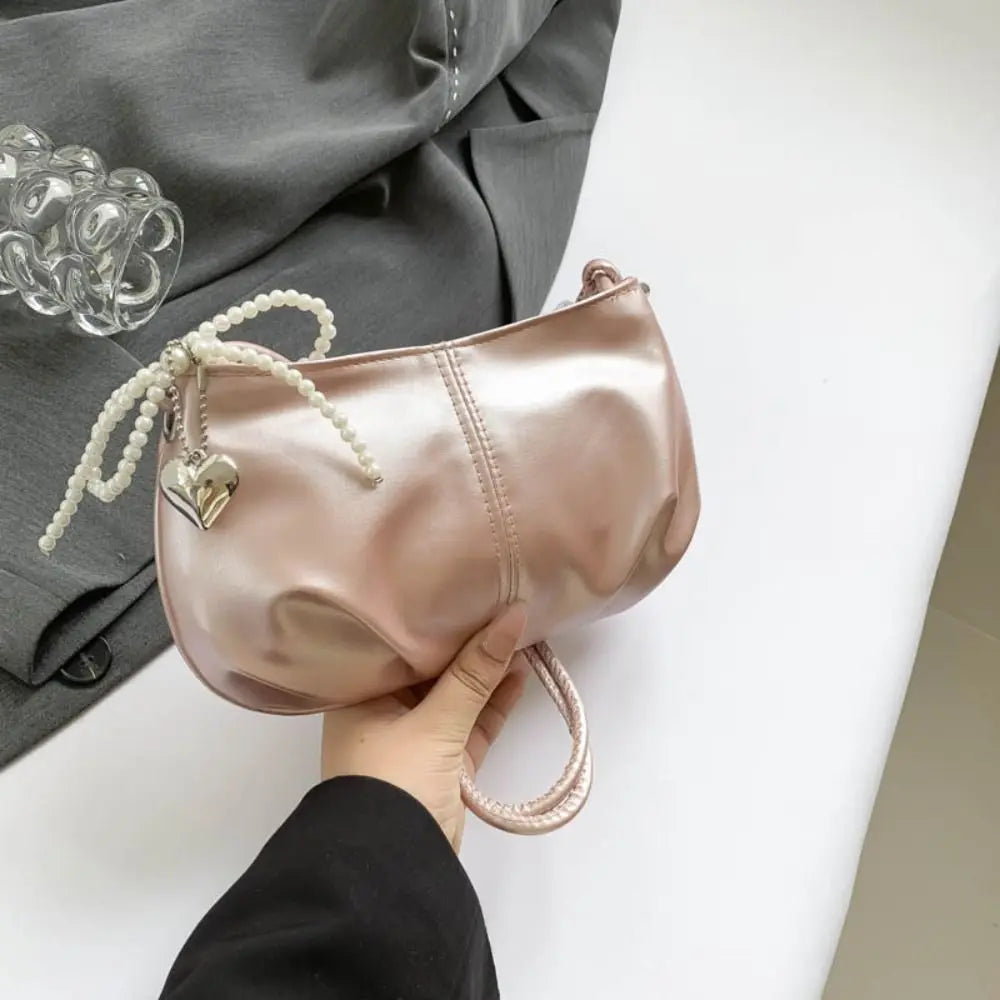 **"Pearlescent Underarm Tote with Bowknot & Pearl Accents"**  
Elevate every outing with Tye Meshun's pearlescent underarm tote. Featuring a charming bowknot detail, a whimsical pearl pendant key ring, and a sleek Y2K-inspire