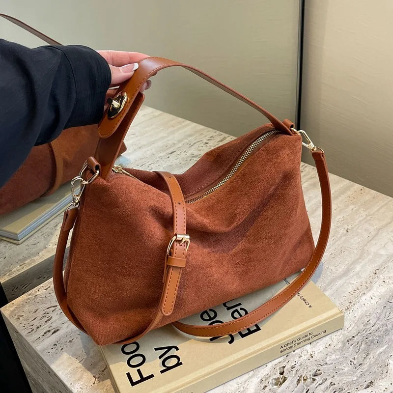 **"Suede Shoulder Bag"**  
Handpicked for Tye Meshun's Boutique, this versatile suede crossbody blends timeless simplicity with high-quality construction. With a secure zipper closure and chic solid design, it's perfect for e