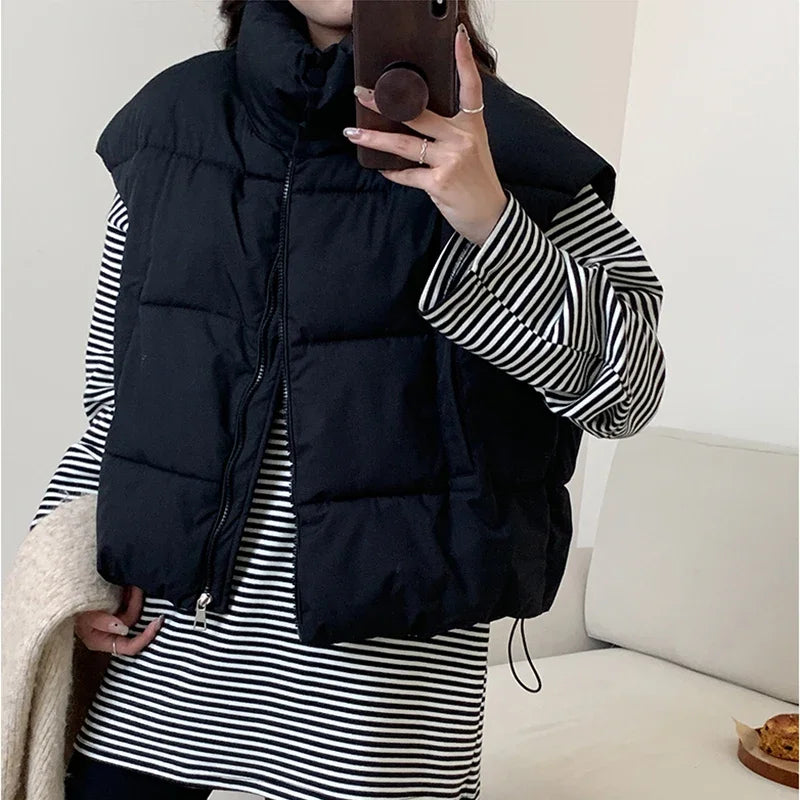 **"Women's Mock Neck Puffer Vest – Warm & Stylish"**  
Stay cozy and chic with Tye Meshun's mock neck puffer vest. Featuring a solid design and zipper closure, this versatile waistcoat offers a loose, comfortable fit perfec