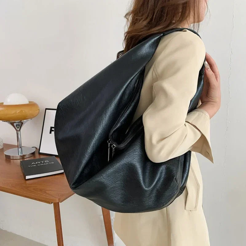 **"Bold Leather Shoulder Bag"**  
Add excitement to your everyday look with Tye Meshun's bold leather shoulder bag. Its roomy hobo design and luxurious craftsmanship make it as functional as it is stylish. Perfect for travel,