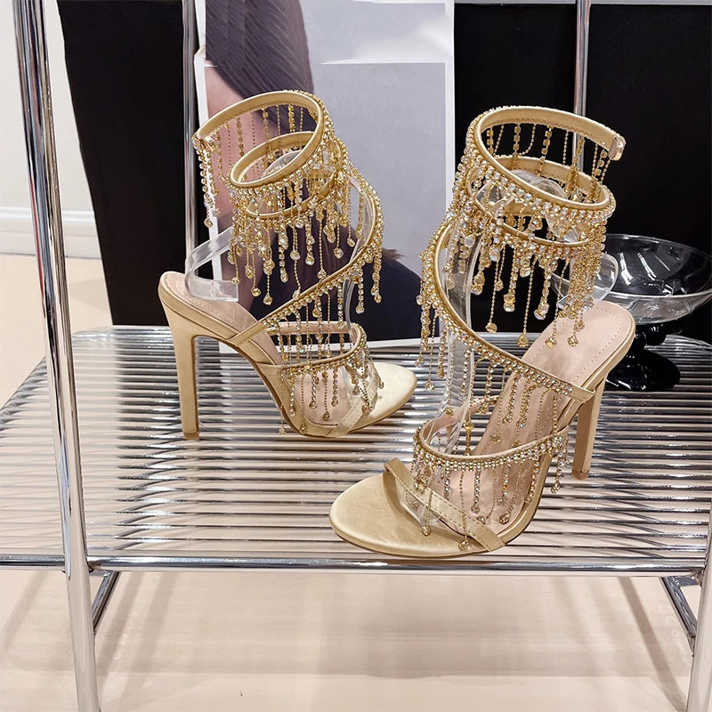 Discover the Aneikeh Fashion collection: dazzling rhinestone sandals with a string bead design, featuring a stiletto heel and wrap strap, complete with a peep toe for a touch of elegance.