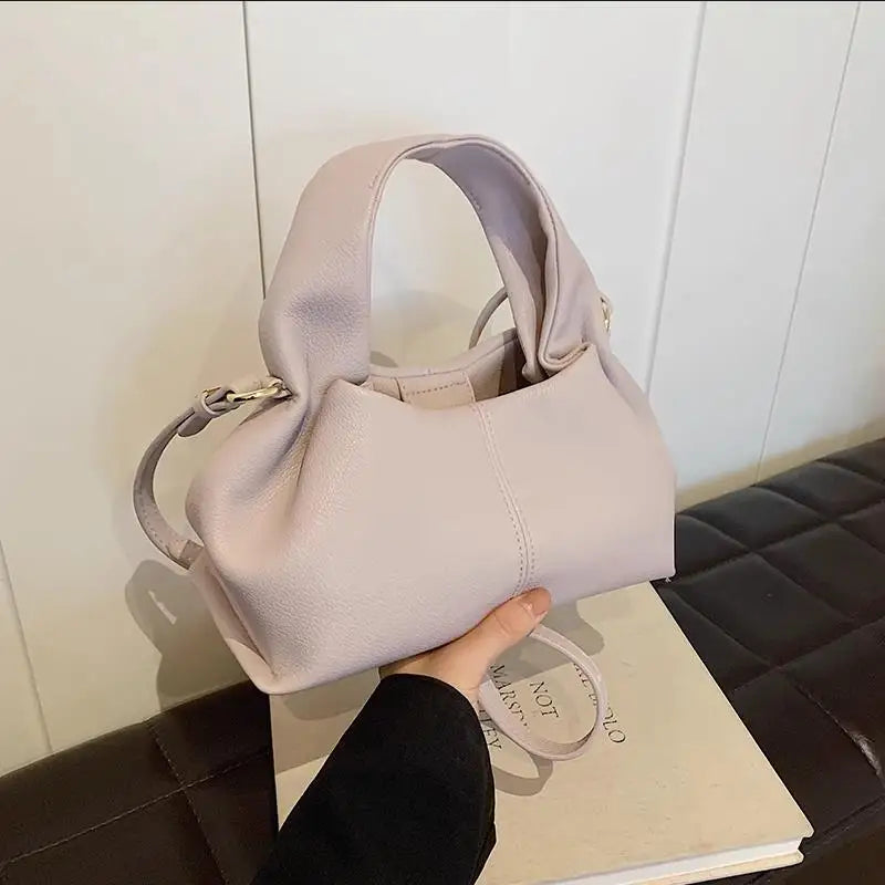 Here’s a season- and date-neutral version:

**"Women's Dumpling Shoulder Crossbody Bag"**  
Elevate your look with Tye Meshun's luxurious top-handle hobo bag. Featuring a chic "dumpling" silhouette, this versatile piece tra