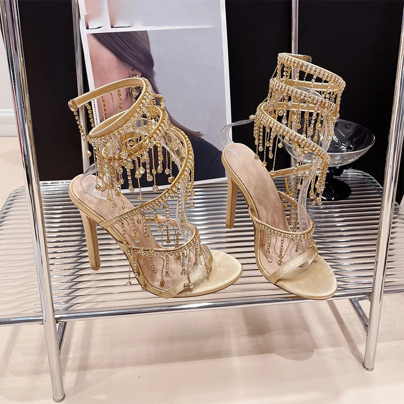 Discover the Aneikeh Fashion collection: dazzling rhinestone sandals with a string bead design, featuring a stiletto heel and wrap strap, complete with a peep toe for a touch of elegance.