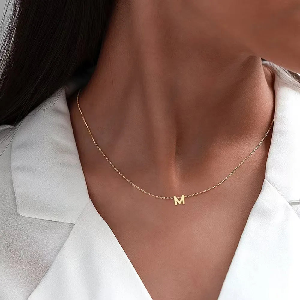 **"Stainless Steel Initial Necklace"**  
Hand-selected for Tye Meshun's Boutique, this gold-tone choker features cut letters for a personal touch. Perfect for layering or gifting, it’s a timeless statement piece.