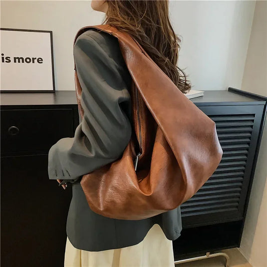 **"Bold Leather Shoulder Bag"**  
Add excitement to your everyday look with Tye Meshun's bold leather shoulder bag. Its roomy hobo design and luxurious craftsmanship make it as functional as it is stylish. Perfect for travel,