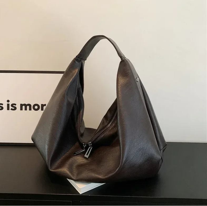 **"Bold Leather Shoulder Bag"**  
Add excitement to your everyday look with Tye Meshun's bold leather shoulder bag. Its roomy hobo design and luxurious craftsmanship make it as functional as it is stylish. Perfect for travel,