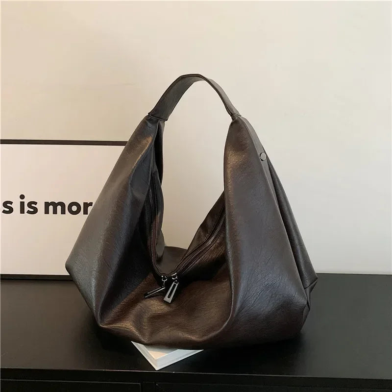 **"Bold Leather Shoulder Bag"**  
Add excitement to your everyday look with Tye Meshun's bold leather shoulder bag. Its roomy hobo design and luxurious craftsmanship make it as functional as it is stylish. Perfect for travel,